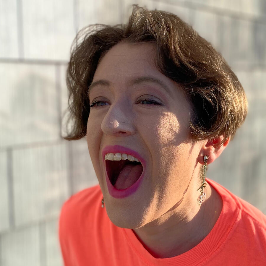 Cee with a wide open mouth as if yelling freely into the void